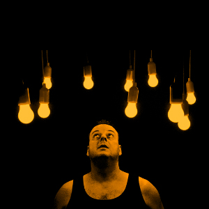 Man staring at light bulbs.